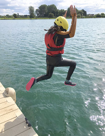 Girl jumping into the lake
