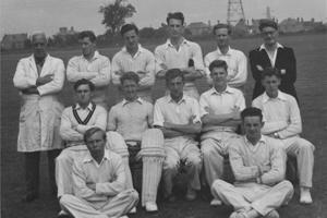 A group of men dressed in cricket whites.