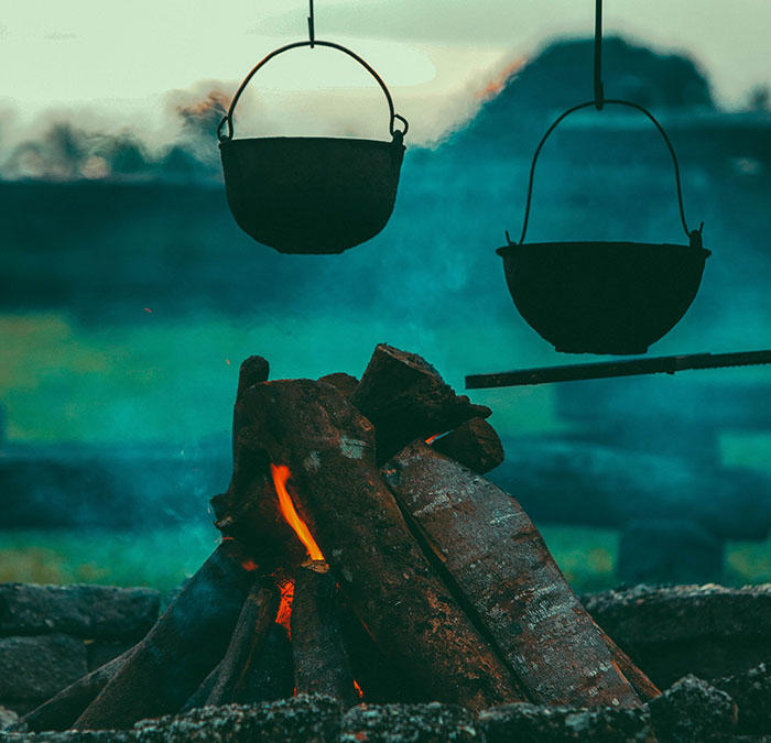 Two cauldrons over an open fire